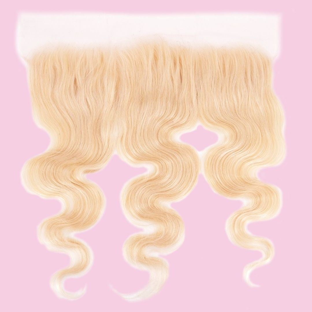 Blonde 613 body wave transparent frontal on pink with the parting space at centre and the wave running to the tips of the hair extensions