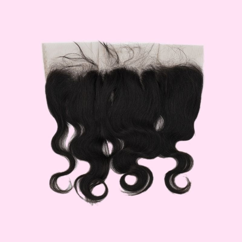 Natural black body wave transparent frontal on a pink background with fine baby hairs along the lace band and waves through the hair extensions