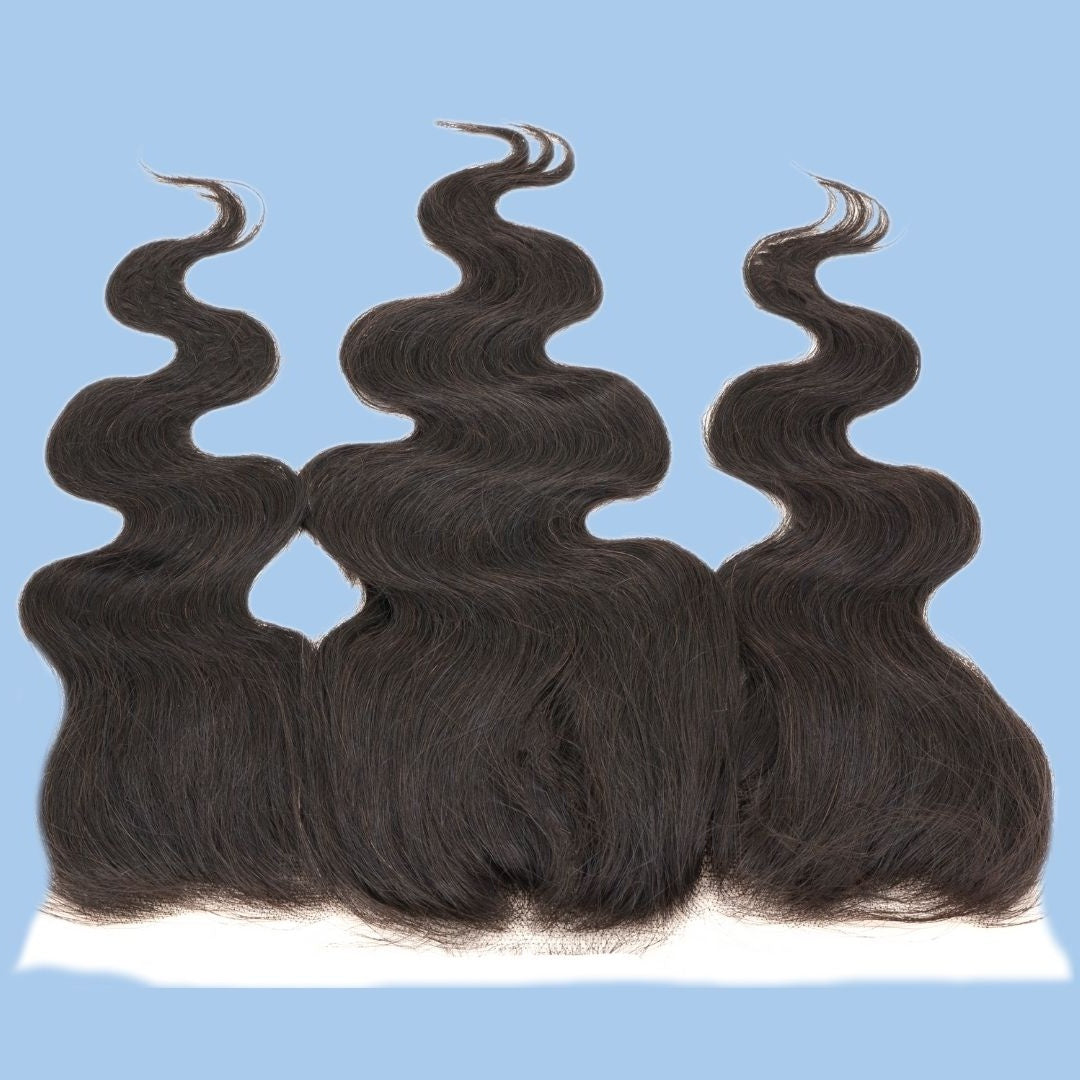 Natural black body wave hair extensions from the transparent frontal shown tips upward on a blue background with the lace edge at the base