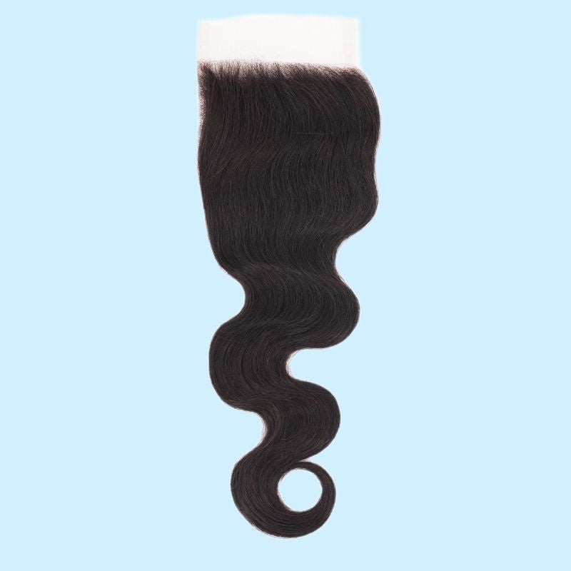 Natural black 4x4 HD closure on a light blue background with the lace panel at the top and body wave hair extensions hanging below