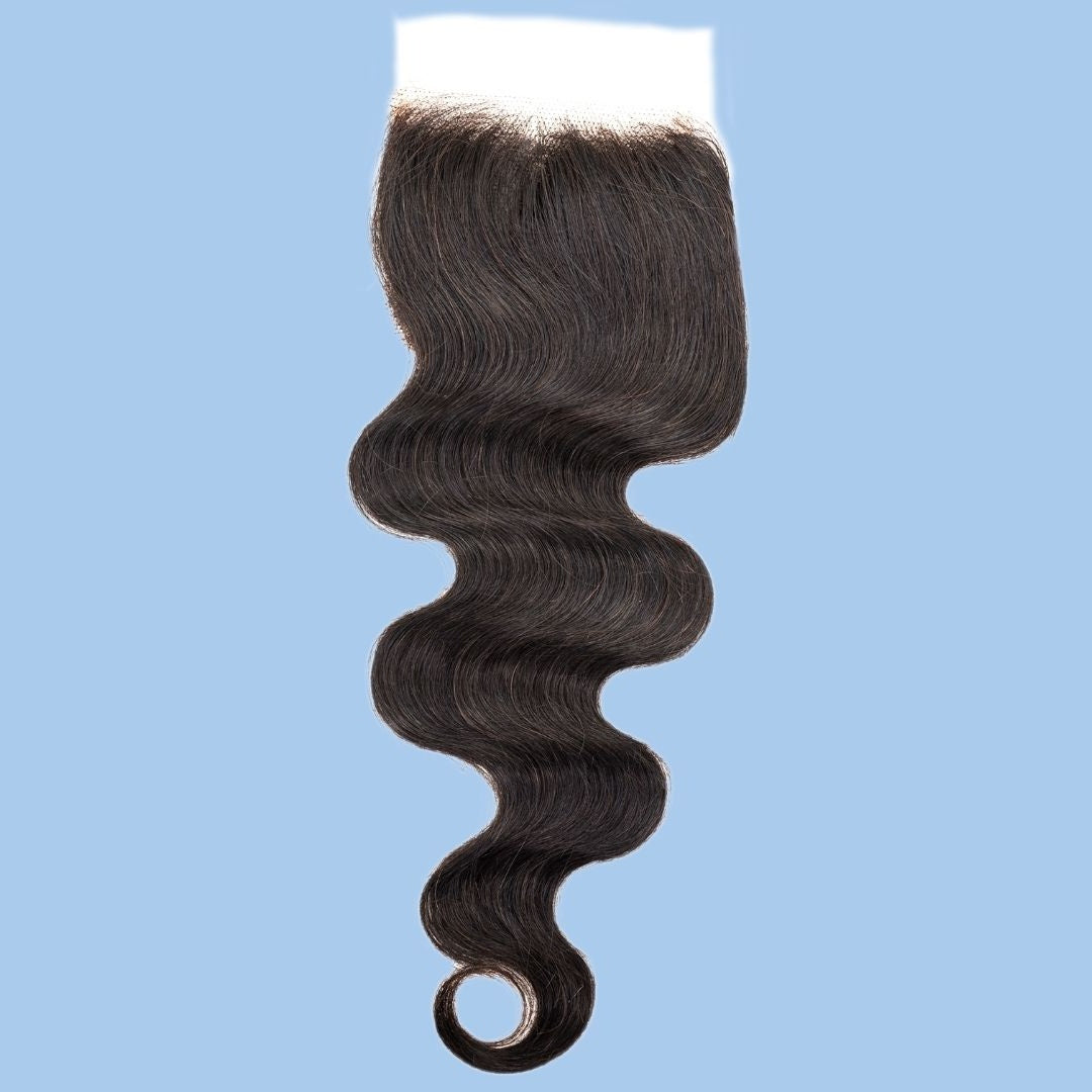 Natural black 4x4 transparent closure on a blue background with the hair side up and the body wave hair extensions curling at the tip