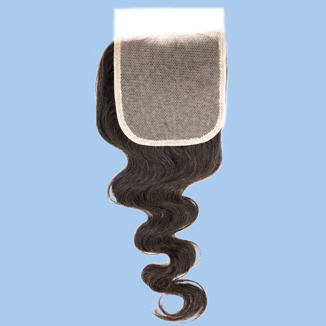 Natural black 4x4 transparent closure shown lace side up on a blue background with the square panel above the body wave hair extensions