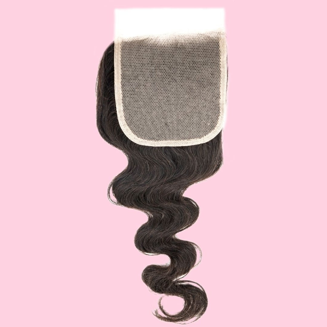 Natural black 4x4 transparent closure lace side up on a pink background with the square lace panel above the body wave hair extensions