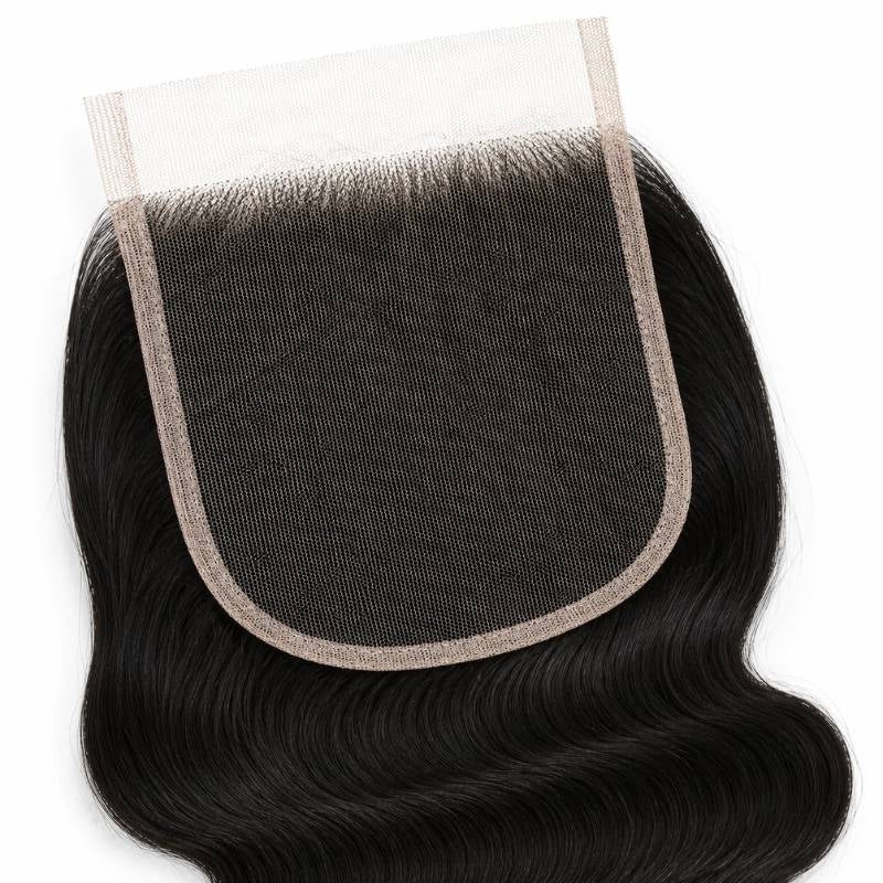 Close-up of the square lace panel and bound edge on a natural black 5x5 HD closure with body wave hair extensions spreading below
