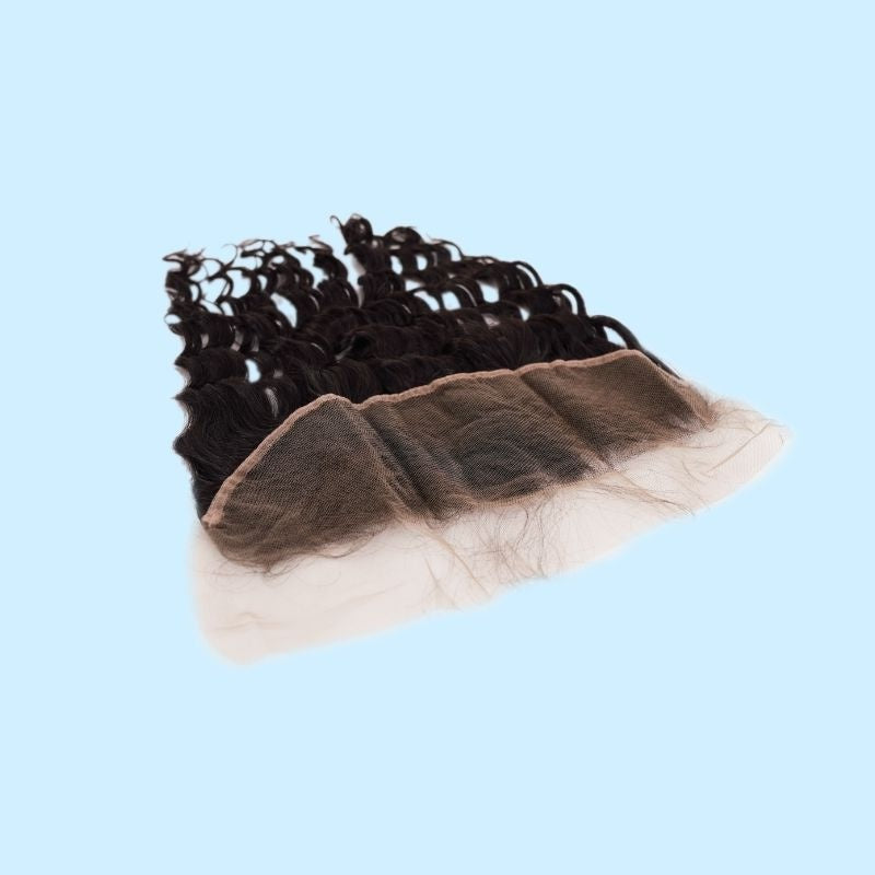 Natural black deep wave transparent frontal tilted on a blue background so the lace panel faces the camera with the curled hair extensions behind