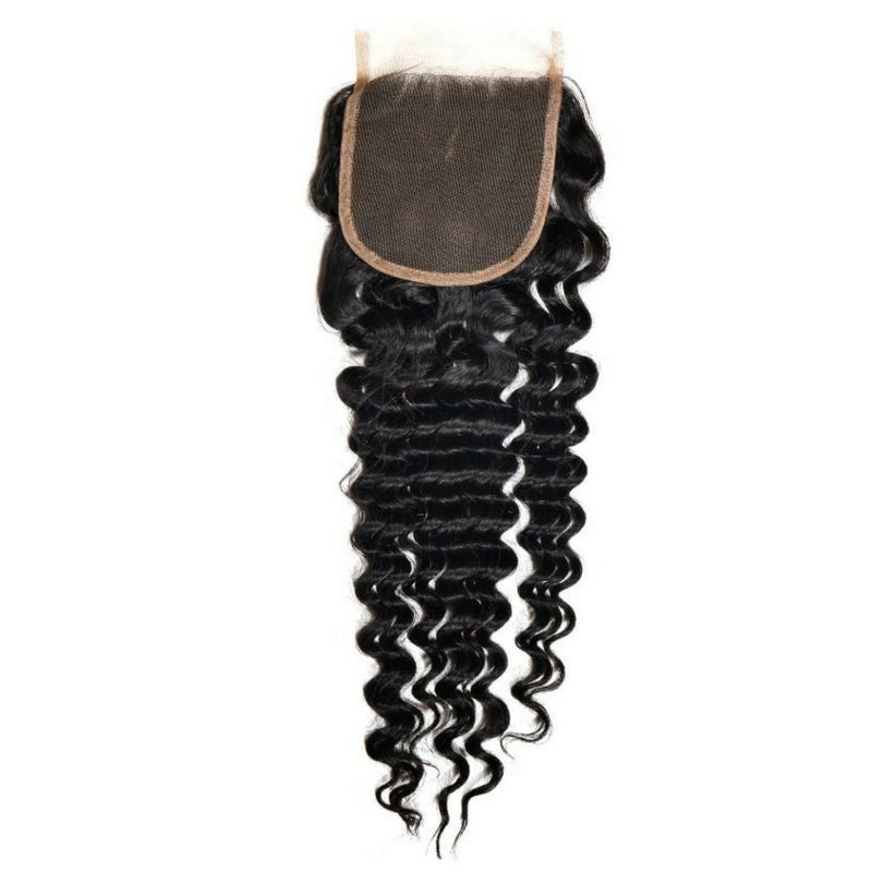 Natural black 4x4 transparent closure turned lace side up on white so the square panel sits above the deep wave hair extensions