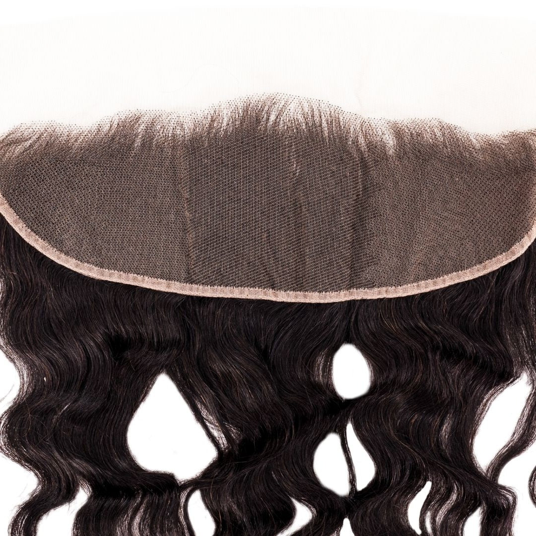 Close-up of the transparent lace mesh and bound edge on the underside of the frontal with natural black loose wave hair extensions