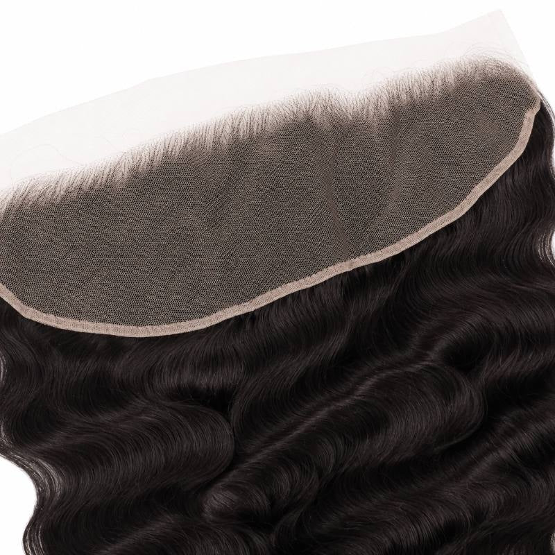 Angled view of the transparent lace panel and its stitched border with natural black loose wave hair extensions falling below