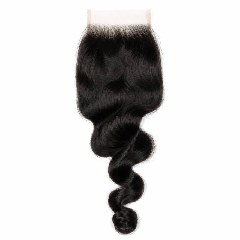 4x4 HD closure laid flat on a white background with natural black loose wave hair extensions falling into a single curl