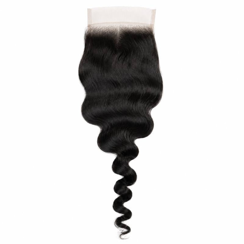 4x4 transparent closure laid flat on a white background showing the full length and spiral tip of natural black loose wave hair extensions