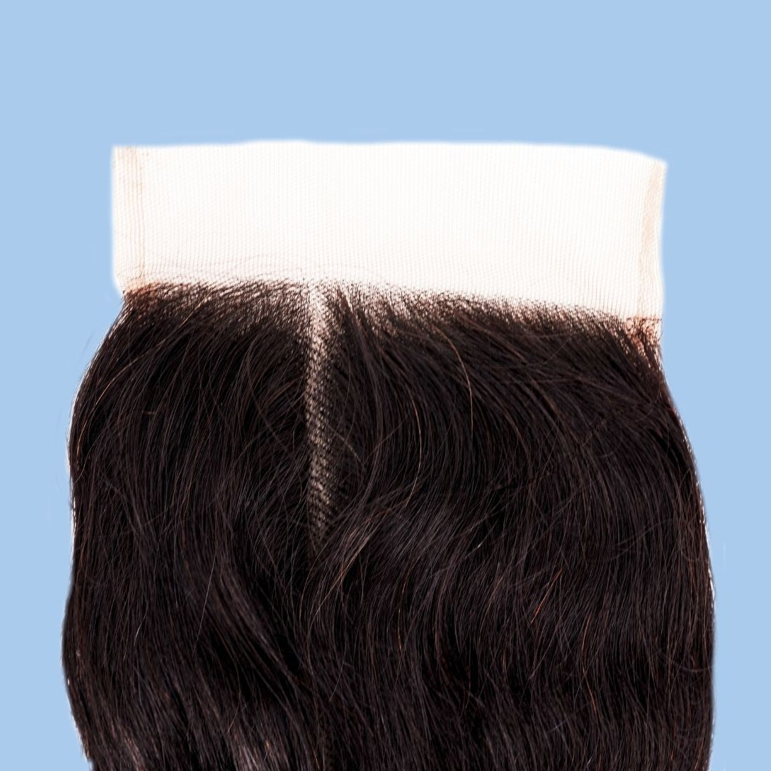 Middle parting and transparent lace band on natural black loose wave hair extensions shown against a blue background