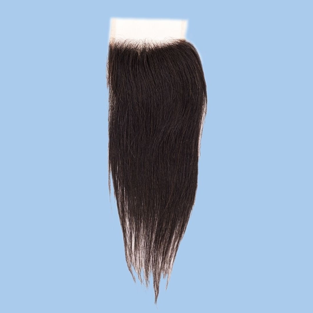Whole 4x4 transparent closure photographed on a blue background showing the lace band and tapered straight natural black hair extensions