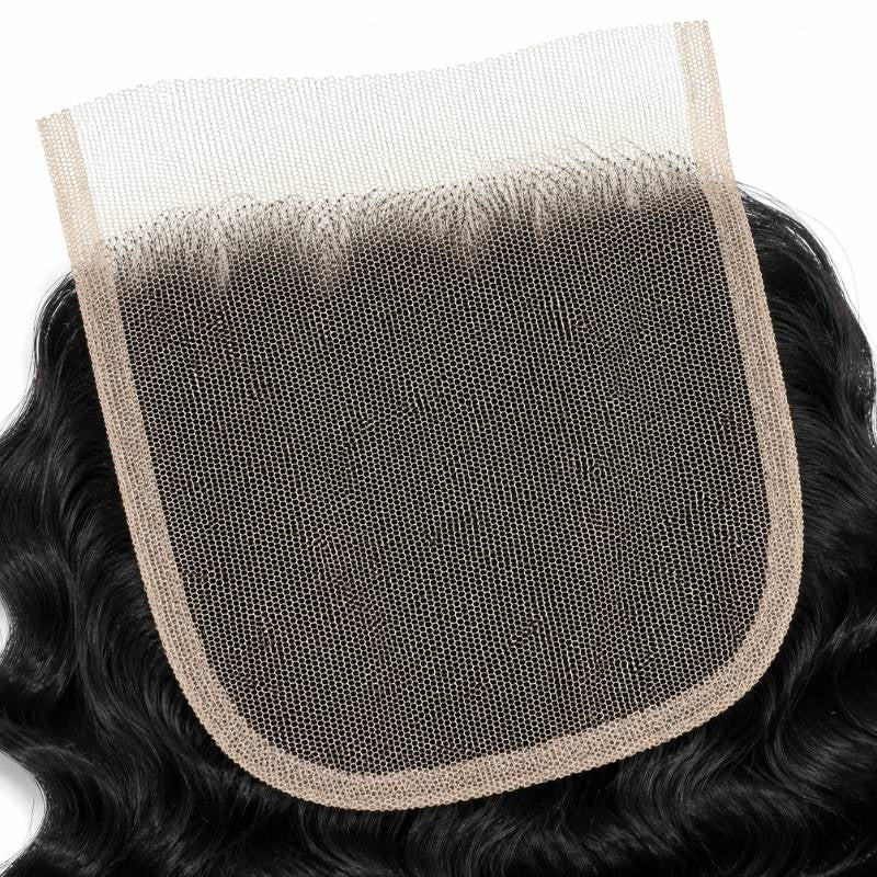 Underside of the 4x4 Swiss lace closure showing the mesh base and knotted hairline with natural black curly hair extensions around it