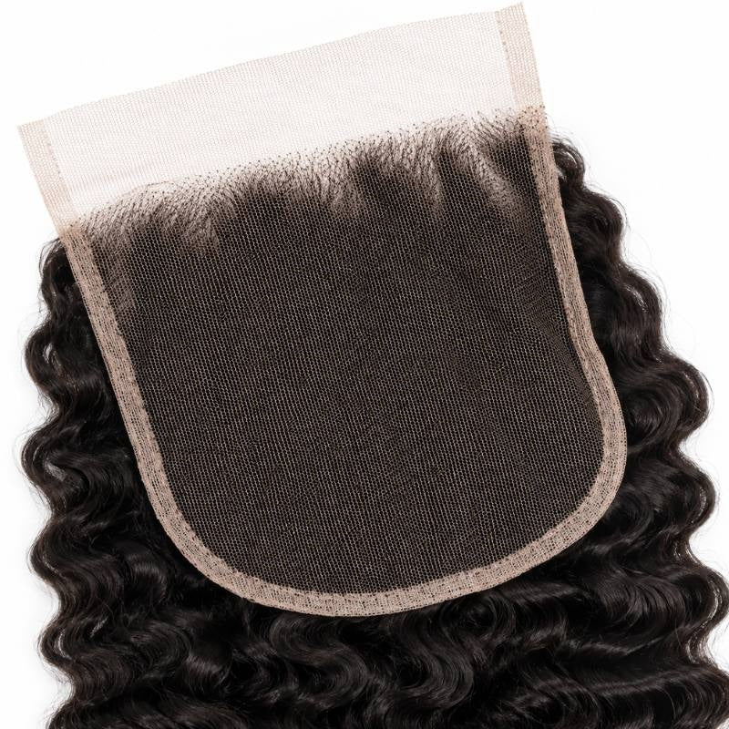 Underside of the 5x5 HD lace closure showing the mesh base and knotted hairline surrounded by natural black curly hair extensions