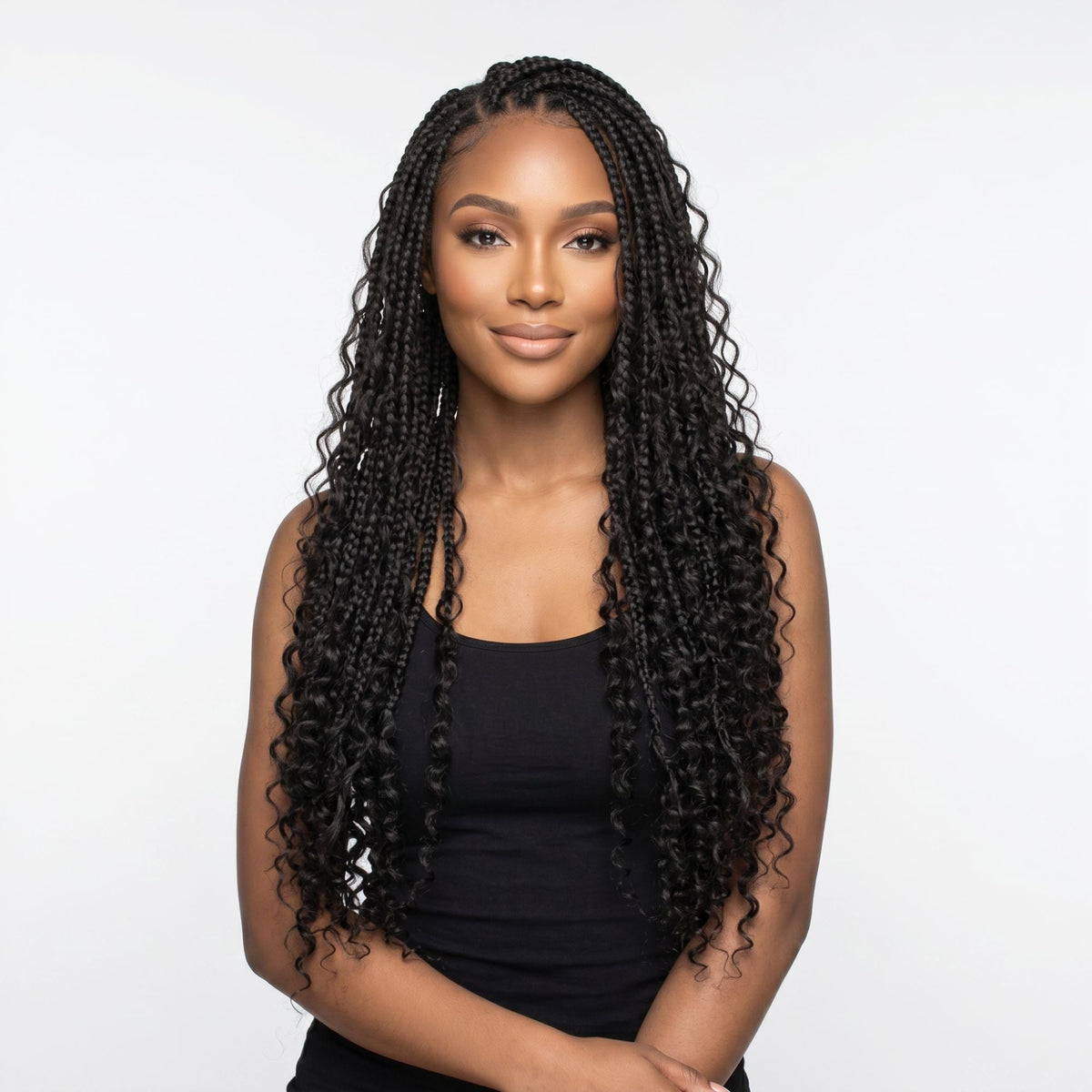 Model wearing box braids with curly ends made from natural black curly bulk braiding hair extensions, front view on a white studio background