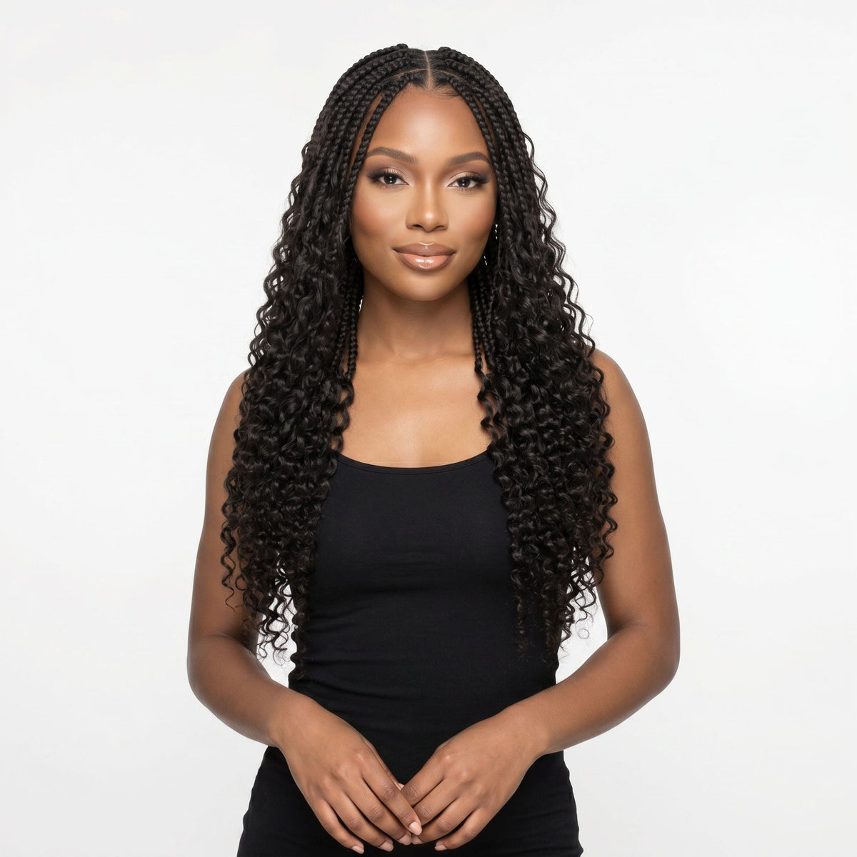 Model wearing boho braids with loose curly ends made from natural black curly crochet hair extensions, front view on a white background