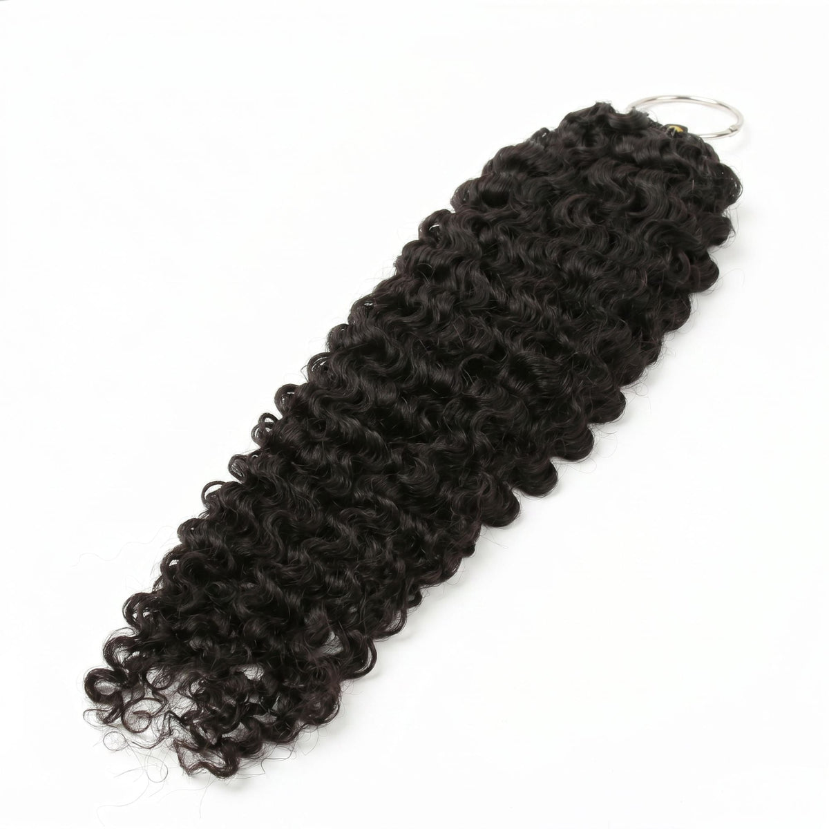 Bundle of natural black curly crochet hair extensions laid diagonally on white with the metal ring at the bound end