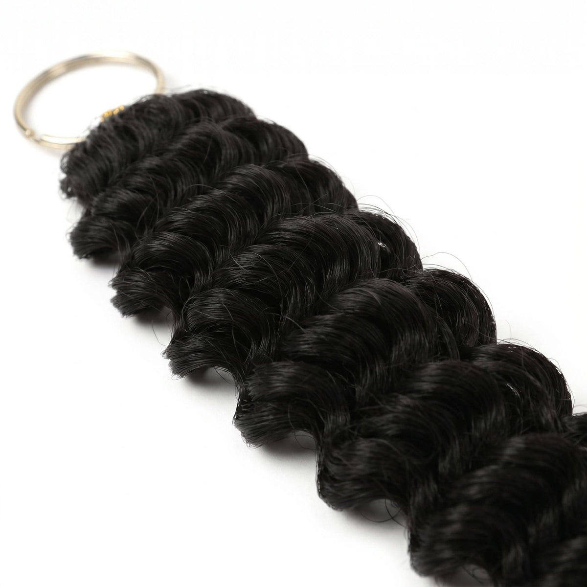 Close-up of the looped attachment end and metal ring on natural black deep wave feather crochet hair extensions