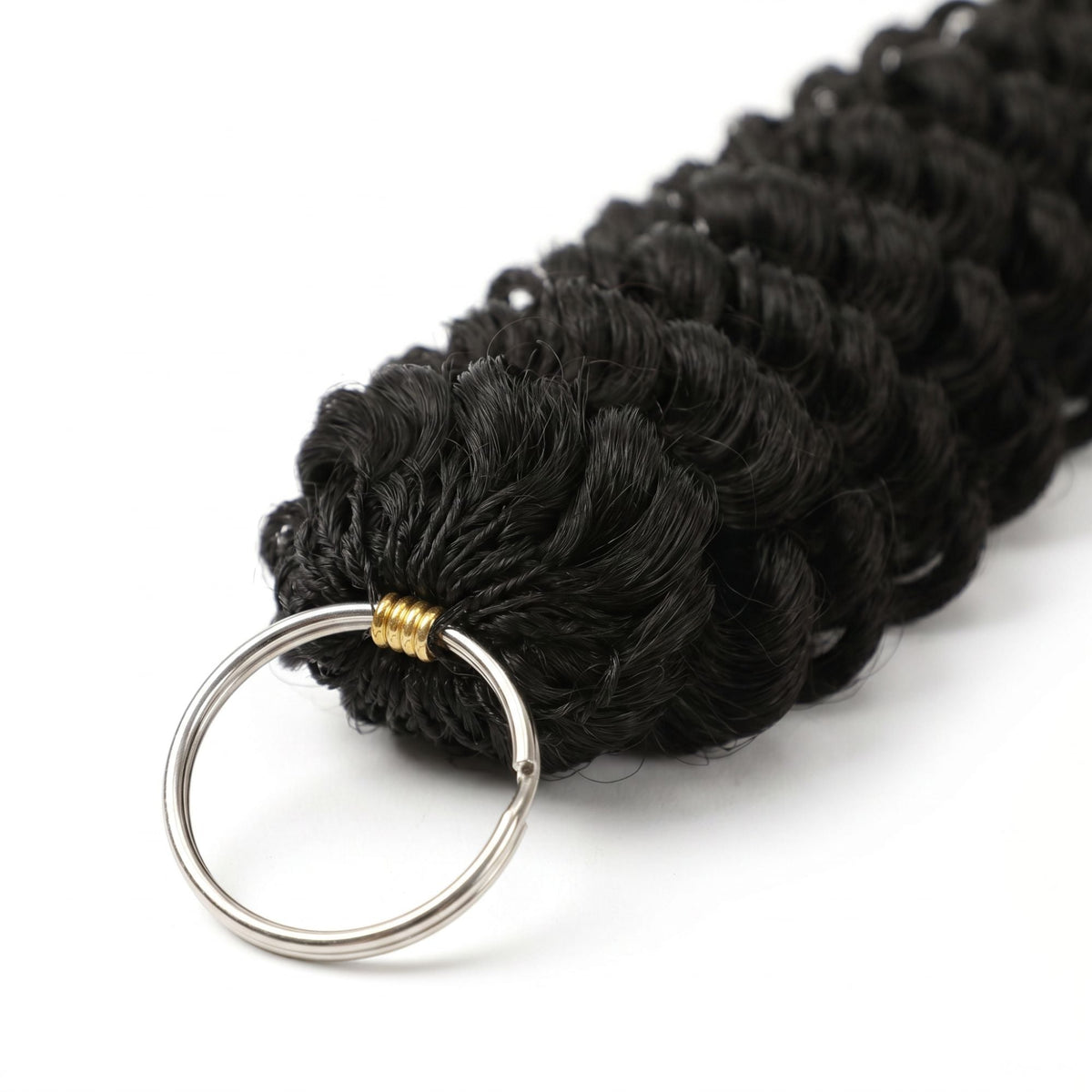 Macro view of the split ring and gold thread binding at the loop end of natural black deep wave feather crochet hair extensions