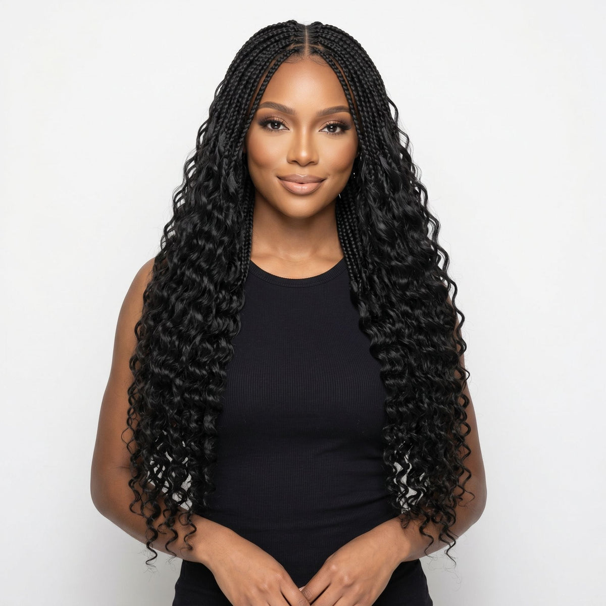 Model wearing natural black deep wave feather crochet hair extensions in boho braids with loose wavy ends on a white background