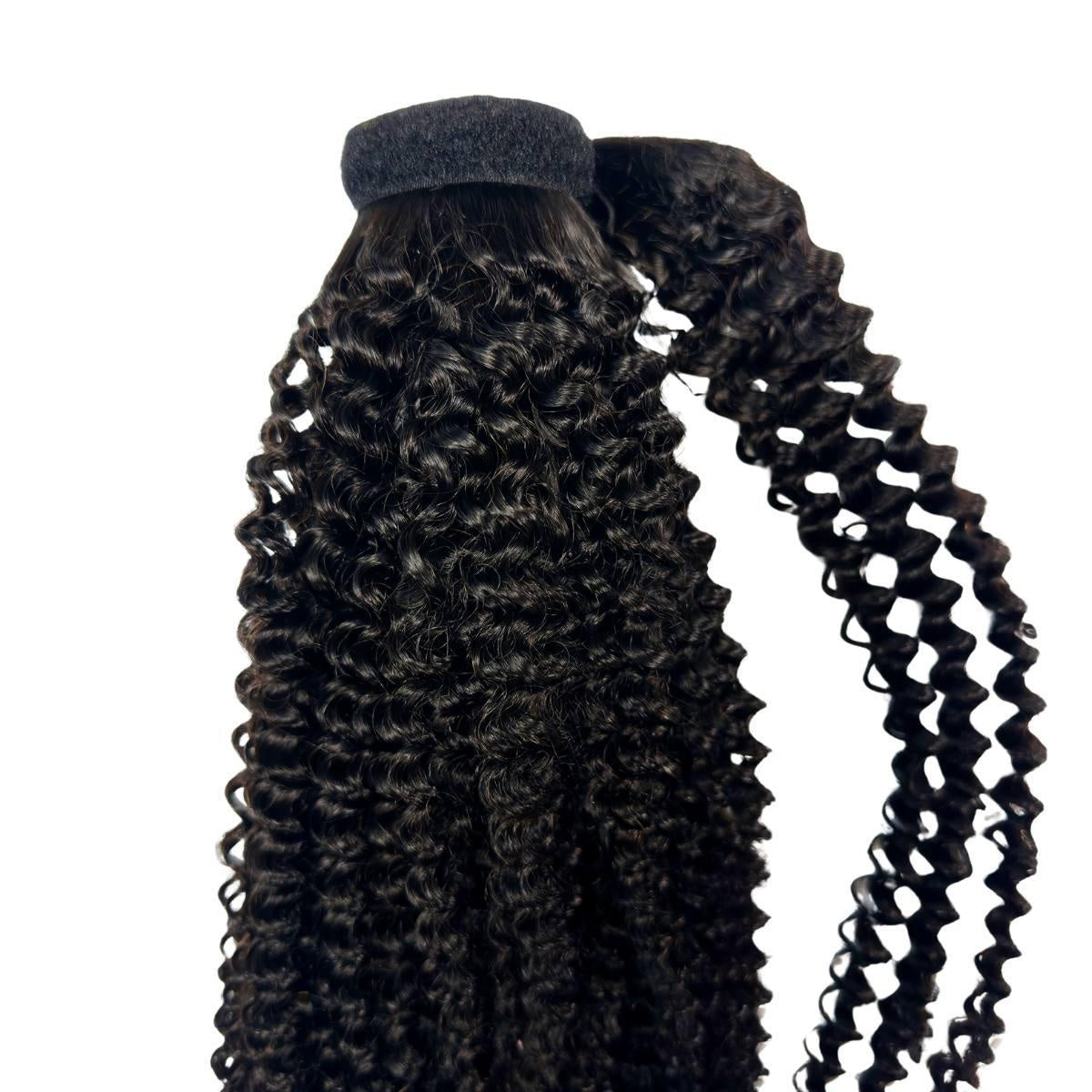 Jerry Curl Ponytail - Jerry curl natural black 1B wrap ponytail showing velcro top band and long spiral curls, side view
