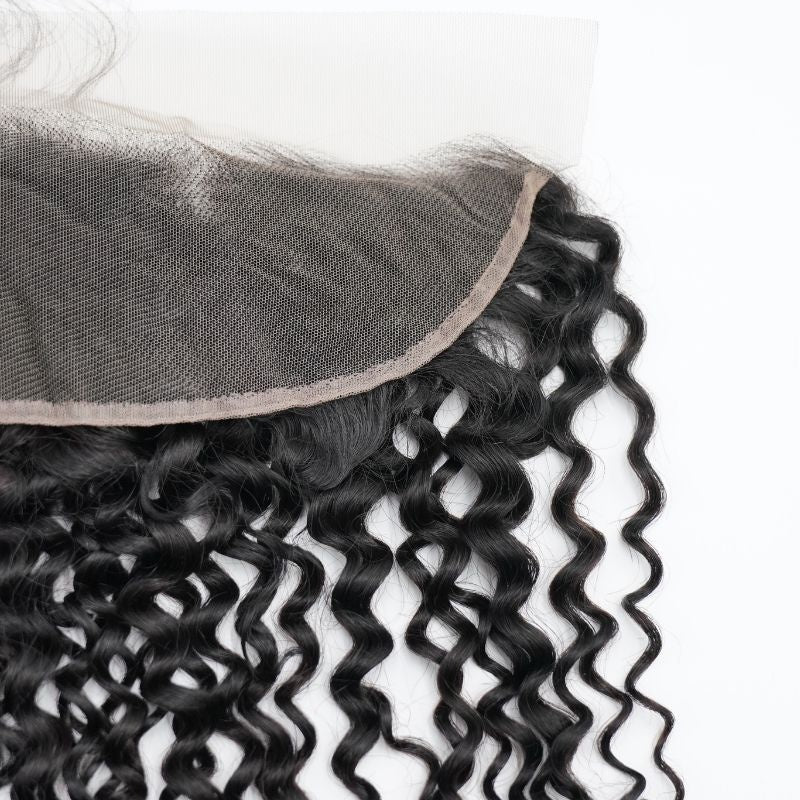 Underside of the transparent lace base on natural black kinky curly frontal hair extensions showing the mesh and bound edge
