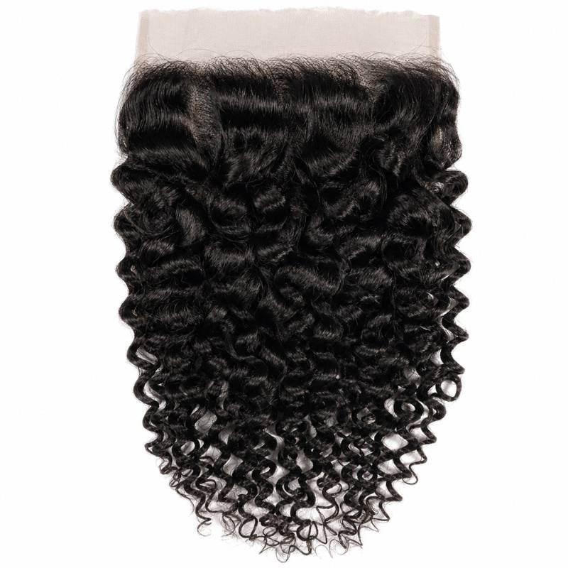 Natural black kinky curly HD lace closure hair extensions laid flat on white showing the wide lace panel and dense coiled curls