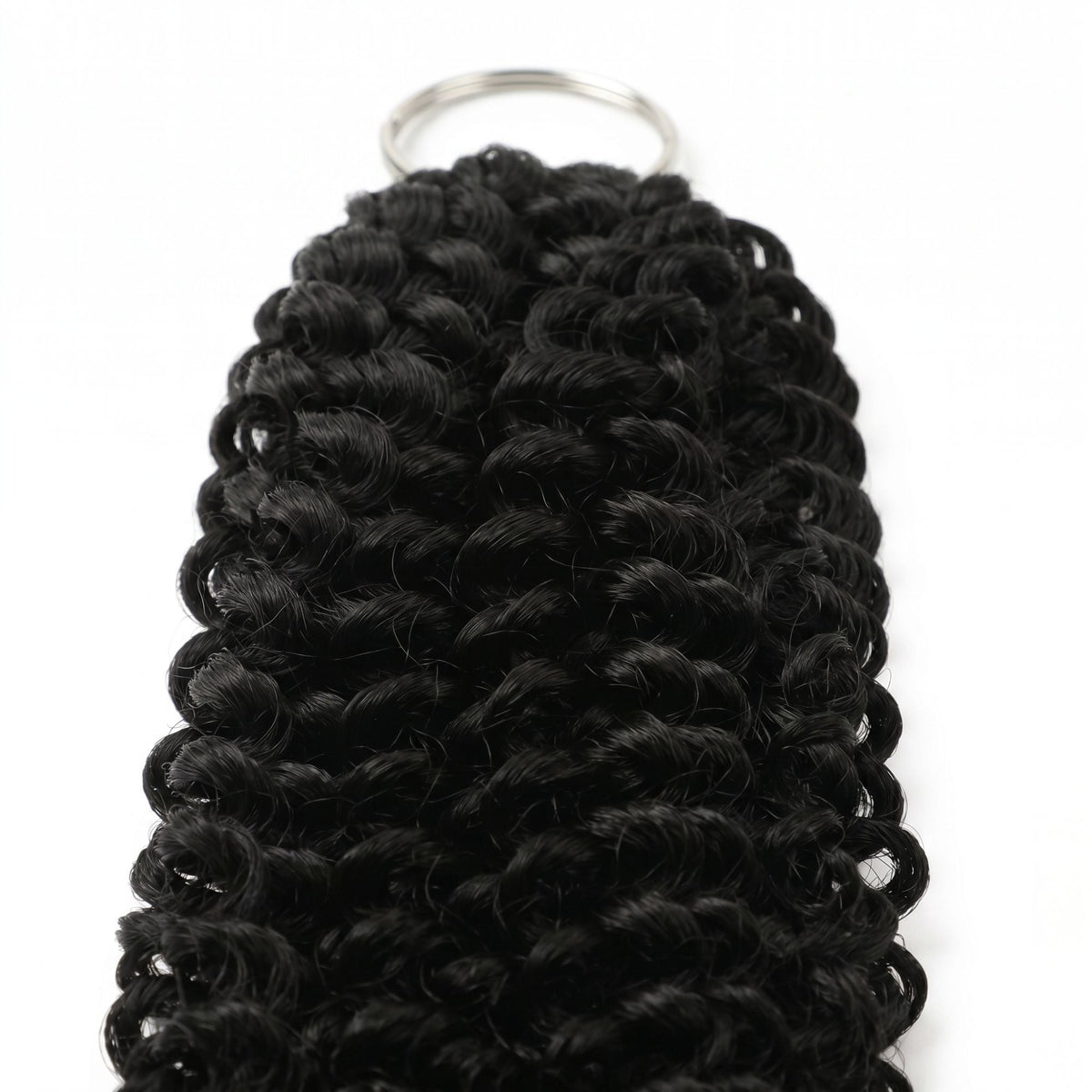 Close-up of the looped end and metal ring on natural black kinky curly feather crochet hair extensions