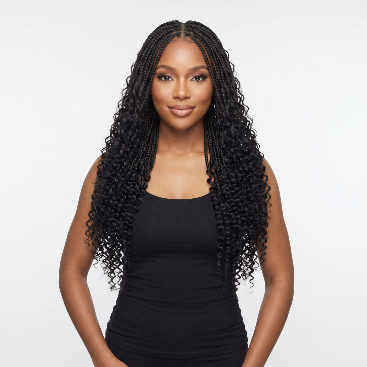 Model wearing natural black kinky curly feather crochet hair extensions in boho braids with loose coiled ends on a white background