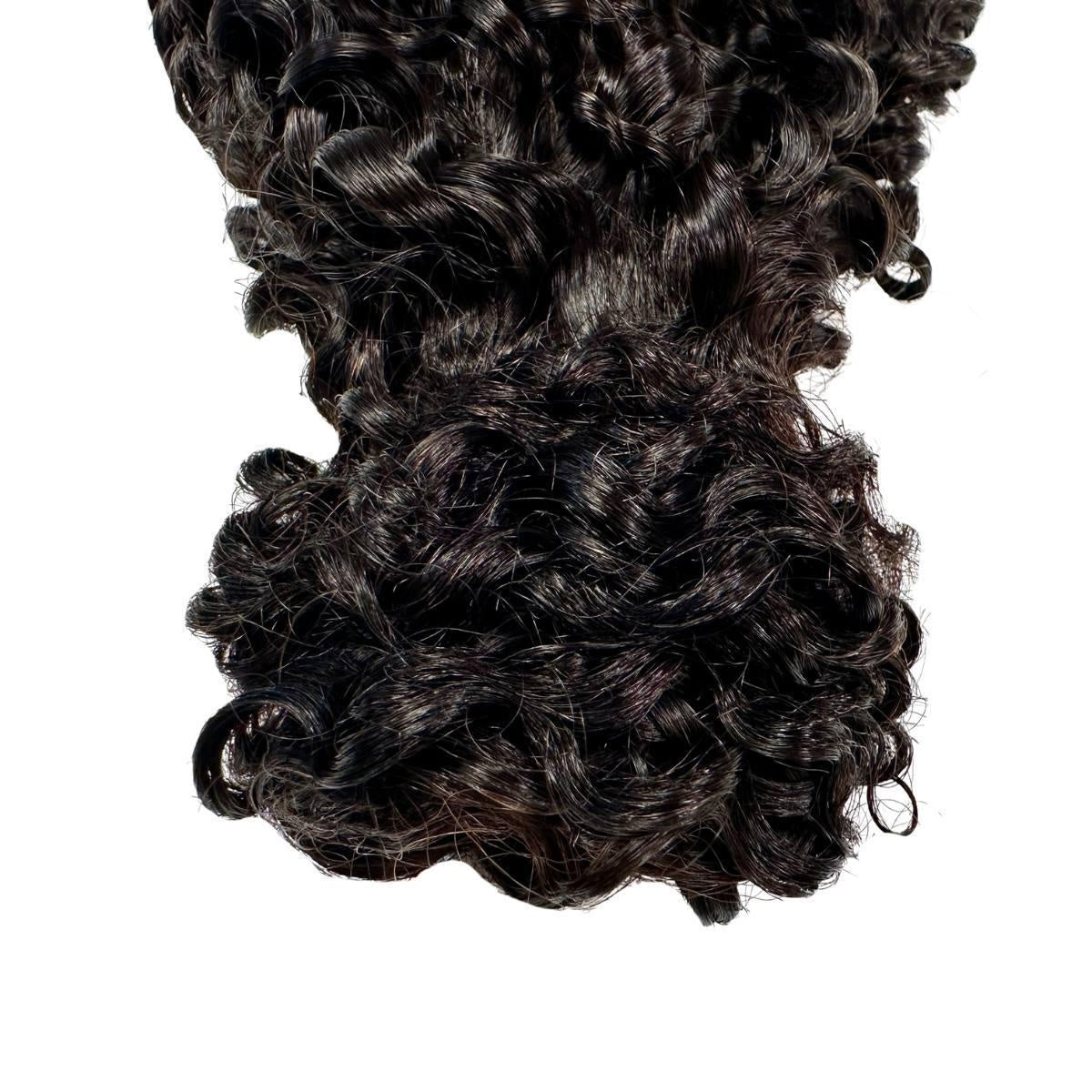 Kinky Curly Ponytail - Close-up of natural black 1B kinky curly ponytail curl texture and tapered ends, product shot on white background