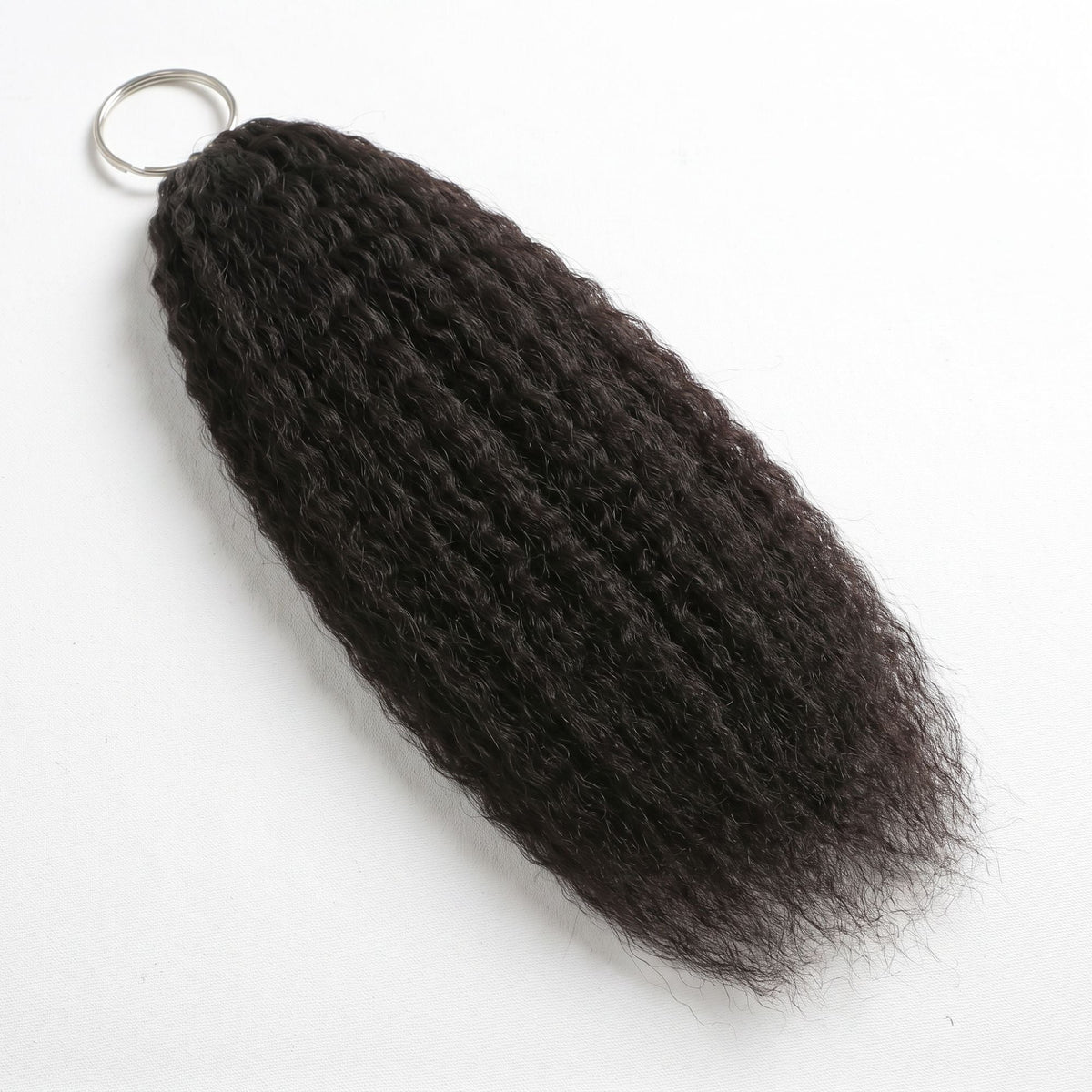 Natural black kinky straight feather crochet hair extensions laid flat on white with the looped end held on a metal ring