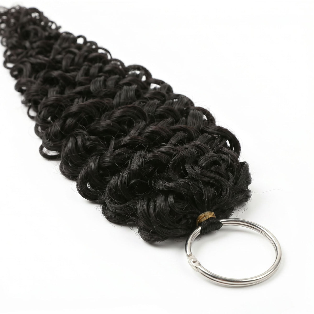 Full hank of natural black ocean wave crochet hair extensions laid diagonally on white with the metal ring at the bound end