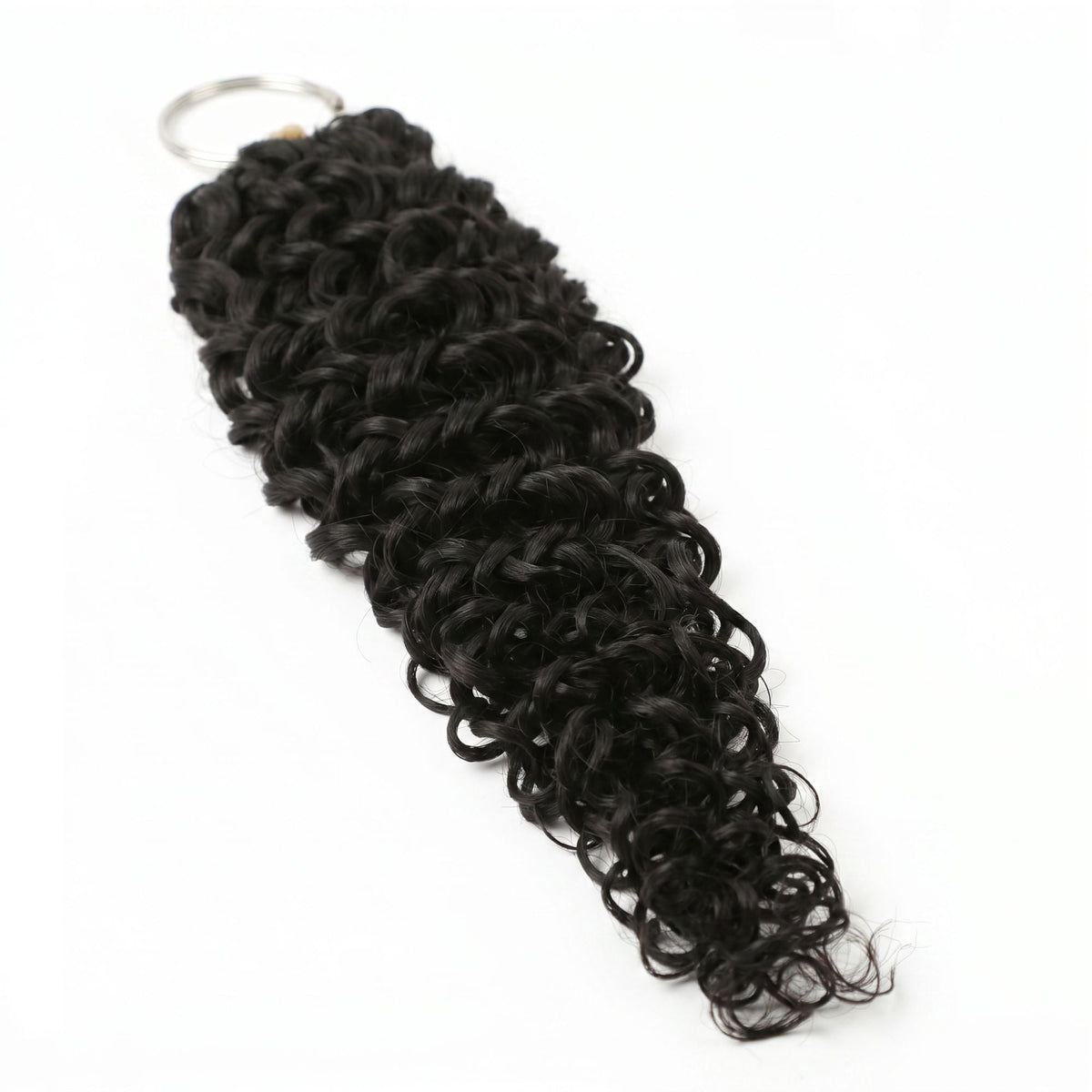 Natural black ocean wave crochet hair extensions laid out with the metal ring at the top of the bound loop end