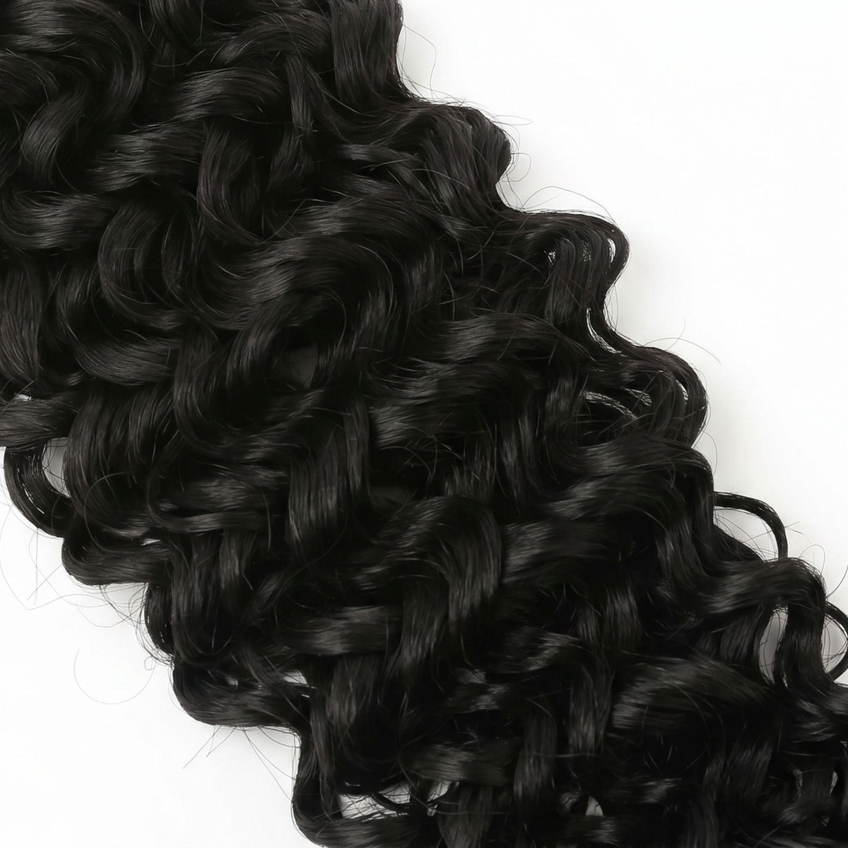 Macro view of the ocean wave curl definition on natural black crochet hair extensions filling the frame