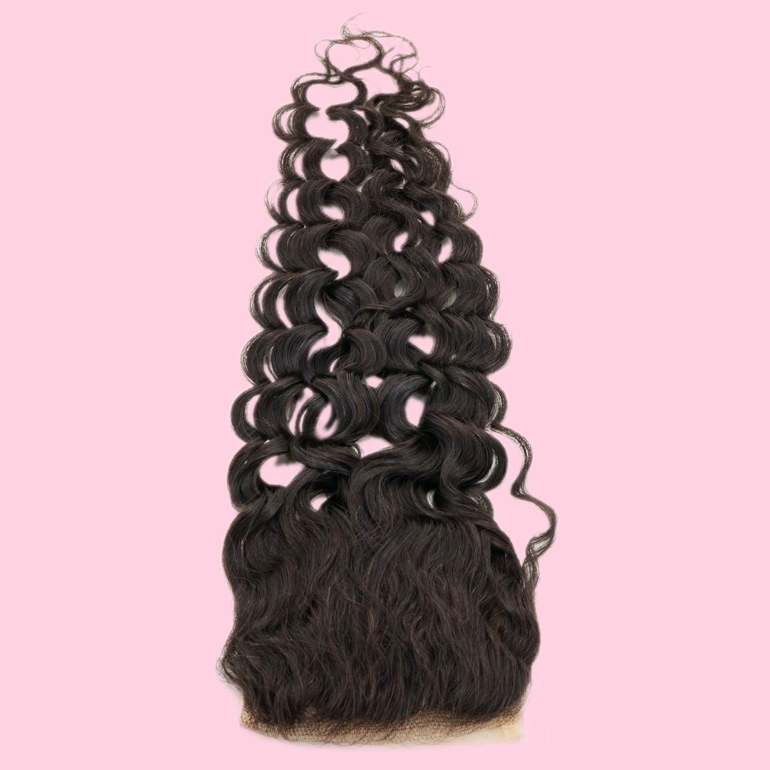 Natural black spiral wave transparent lace closure hair extensions stood on the lace base on a pink backdrop with the hair rising upward
