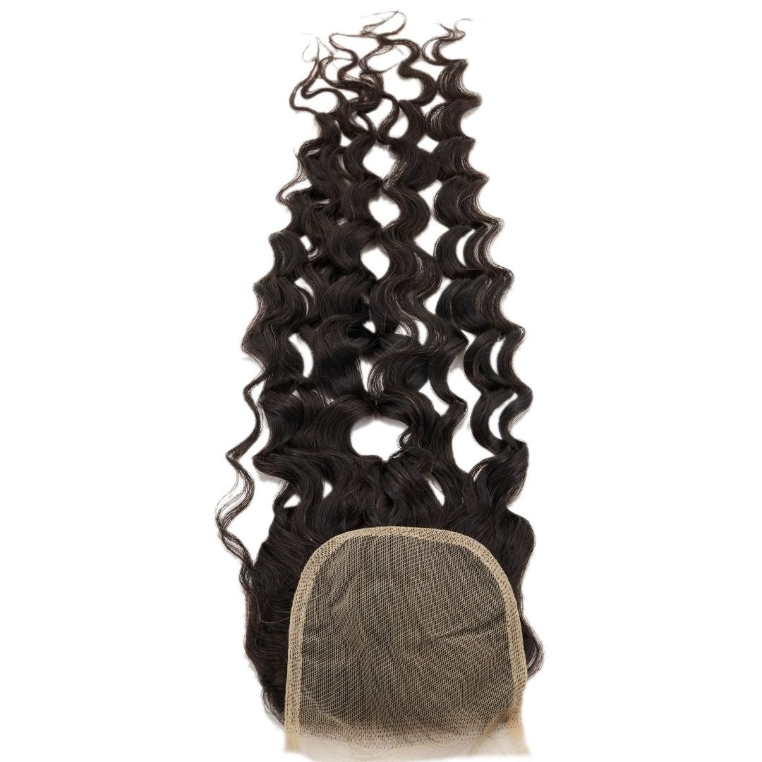 Natural black spiral wave transparent lace closure hair extensions turned over to show the square lace base with the hair spread behind it