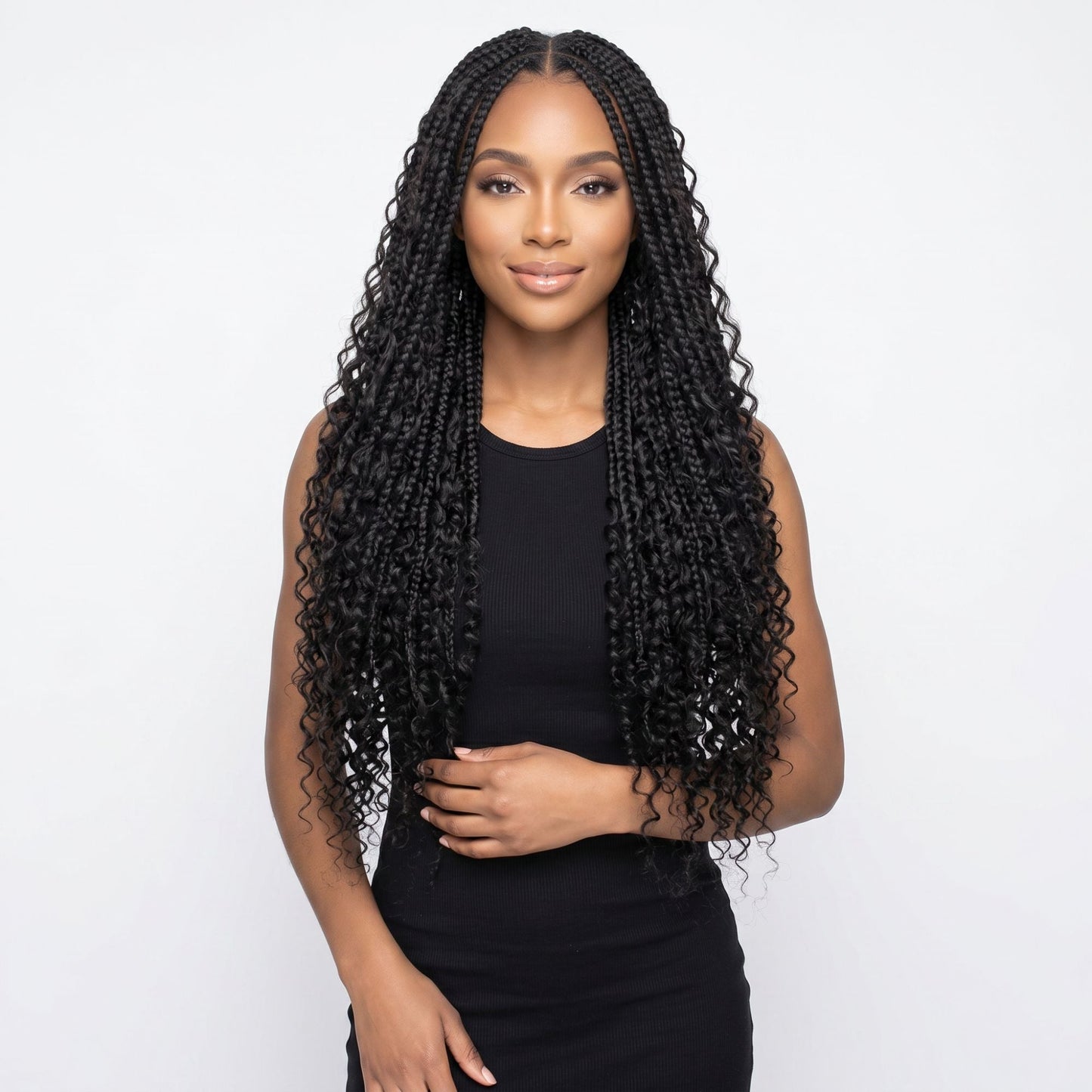 Model wearing long boho braids with water wave curly ends in natural black bulk braiding hair extensions on a white background