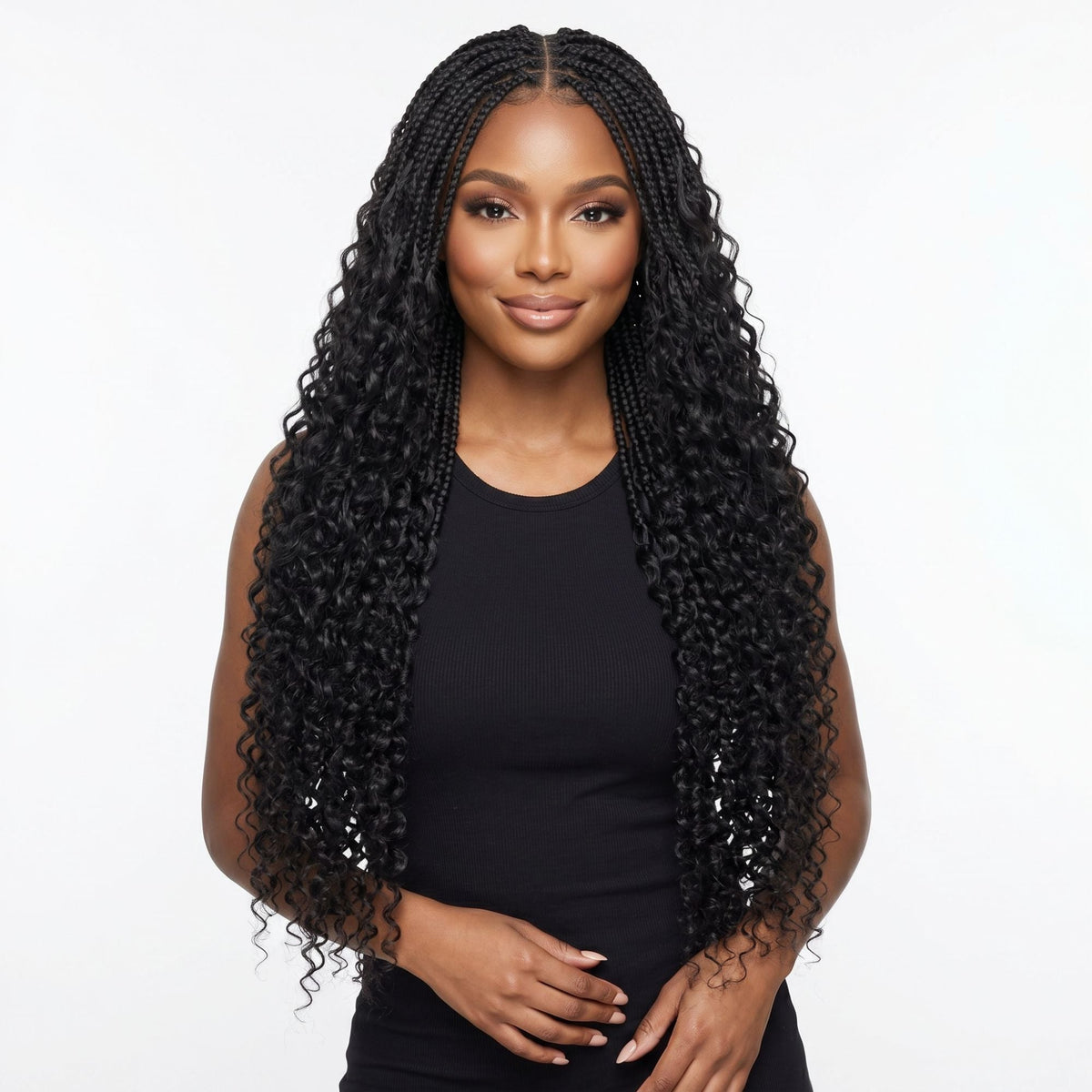 Model wearing boho braids with water wave curly ends in natural black crochet hair extensions, hands clasped in front on a white background