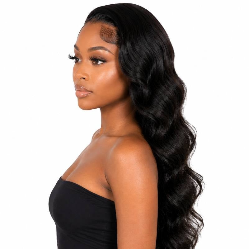 Side profile of a model wearing a long body wave natural black human hair wig with styled baby hairs at the temple and waves down her back