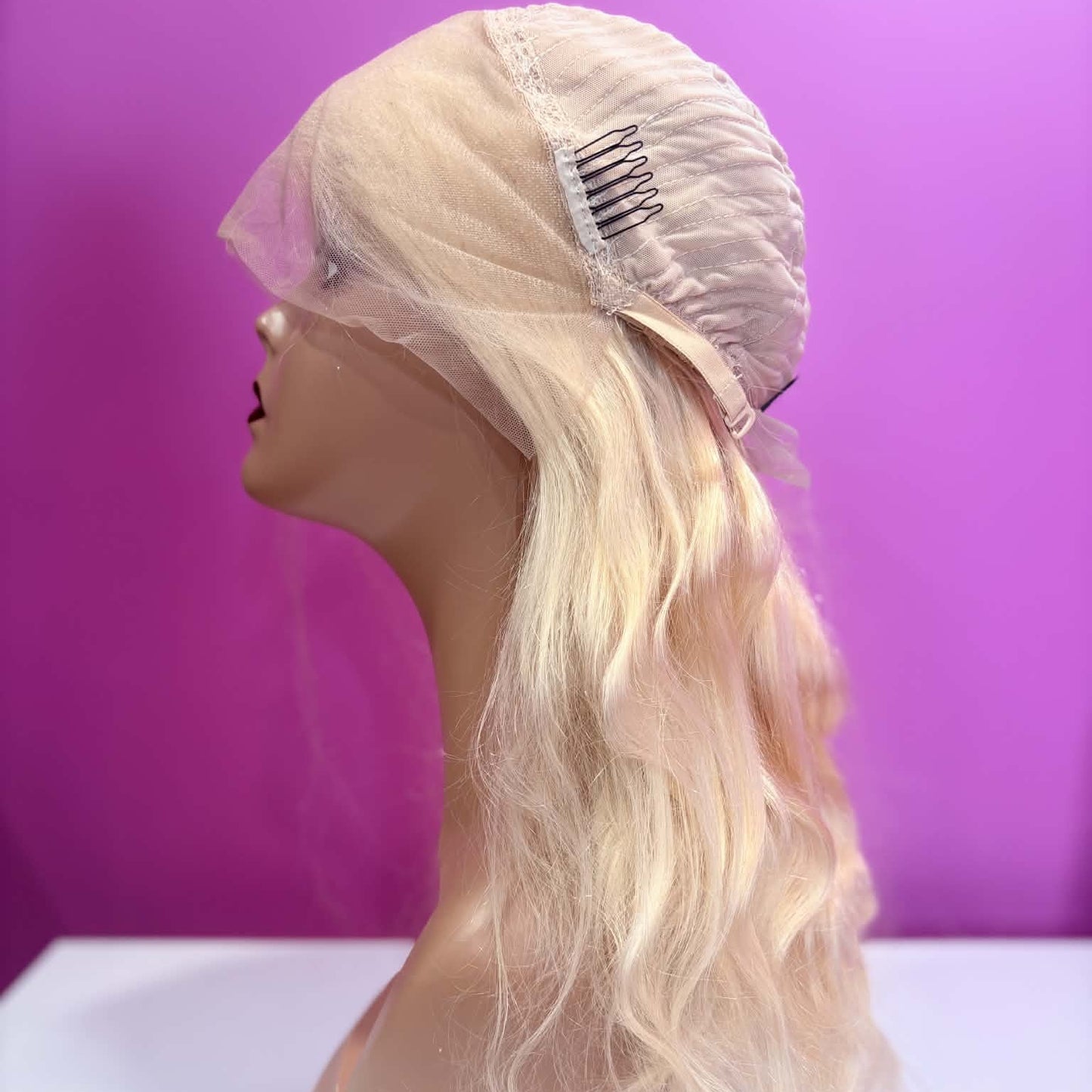 Left side cap construction of 16 inch blonde body wave lace front human hair wig showing weft rows and lace edge