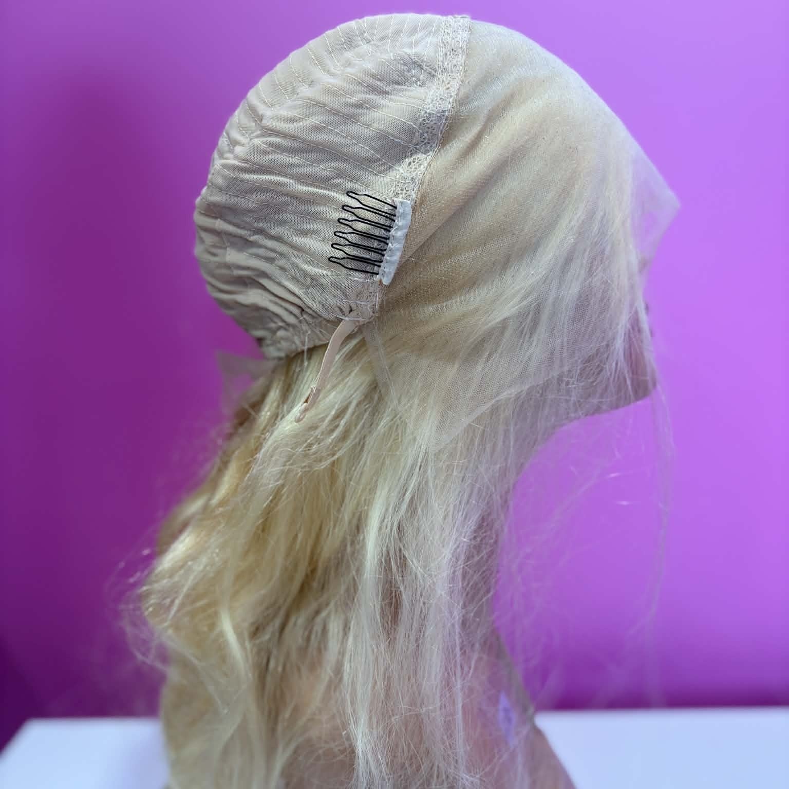 Right side cap construction of 16 inch blonde body wave lace front human hair wig showing machine-made weft rows