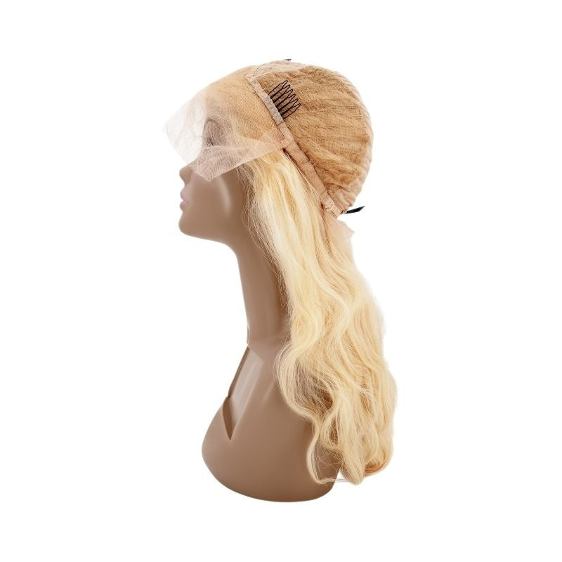 Blonde body wave human hair wig turned inside out on a mannequin bust showing the cap dome, a crown comb and the lace front panel