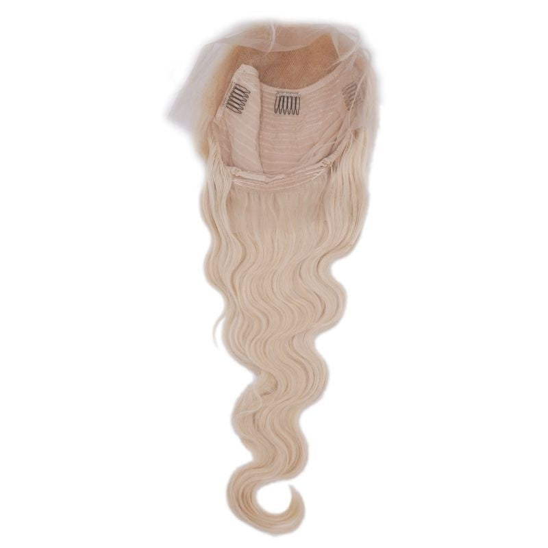 Blonde body wave human hair wig laid open on white showing the cap opening with three combs and the waved length hanging below