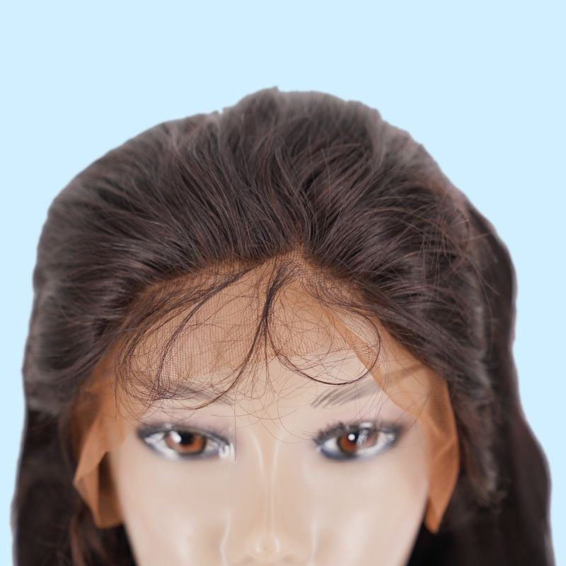 Close-up of the front hairline on a body wave natural black human hair wig showing the transparent lace panel and stray baby hairs