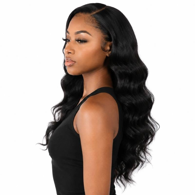 Model turned to the side wearing a long body wave natural black human hair wig with a visible part line and waves down the back