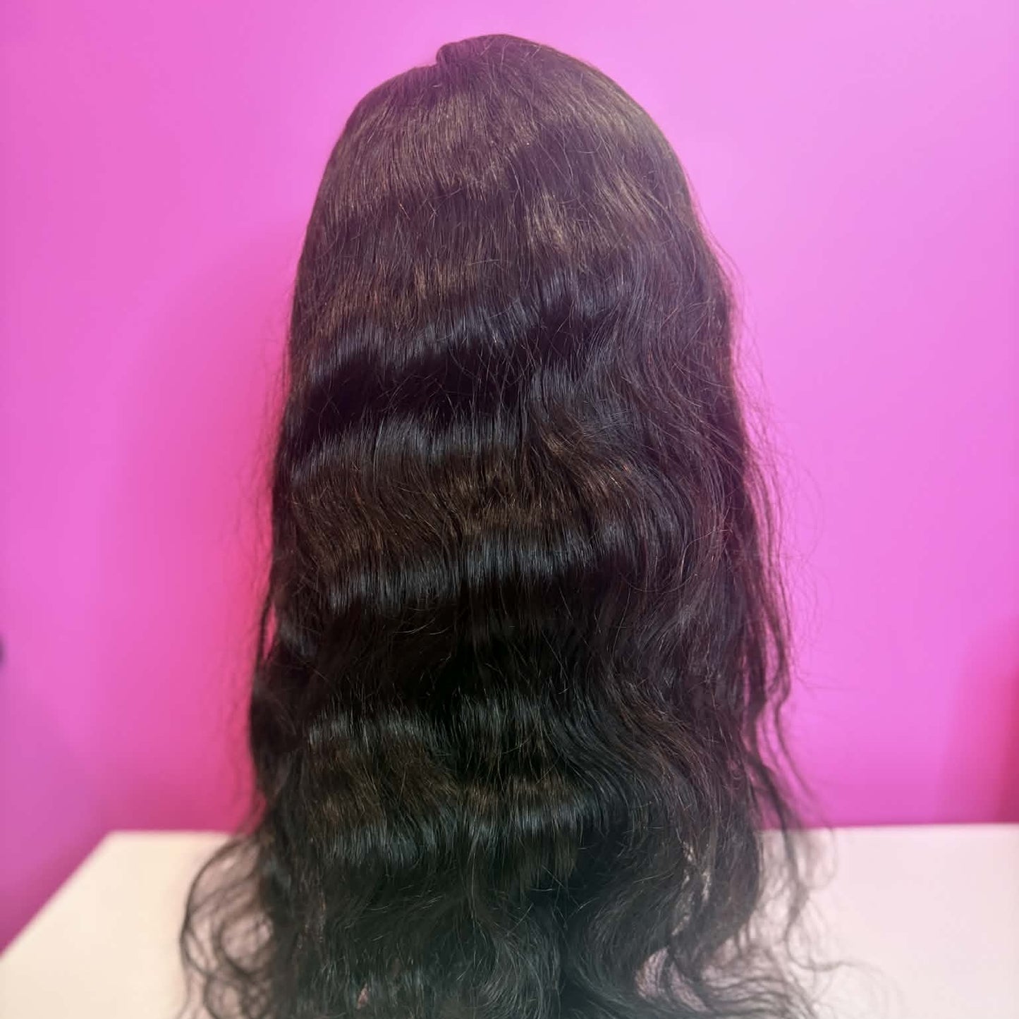 Back view of 18 inch body wave full lace human hair wig on mannequin showing S-wave pattern and length