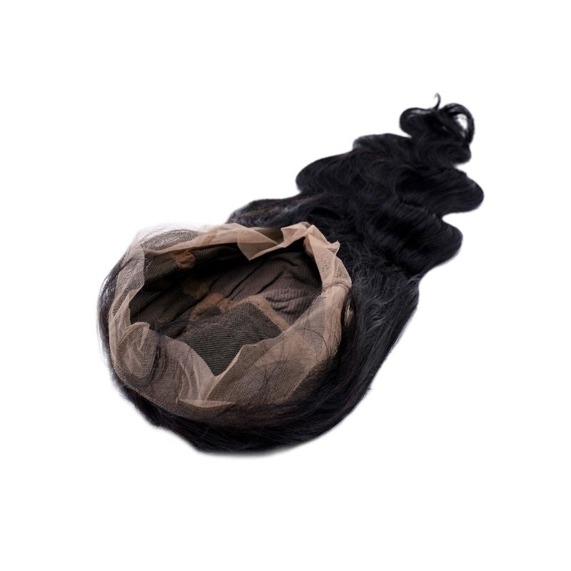 Body wave natural black human hair wig set on its side showing the open full lace cap and the waved hair fanning out behind