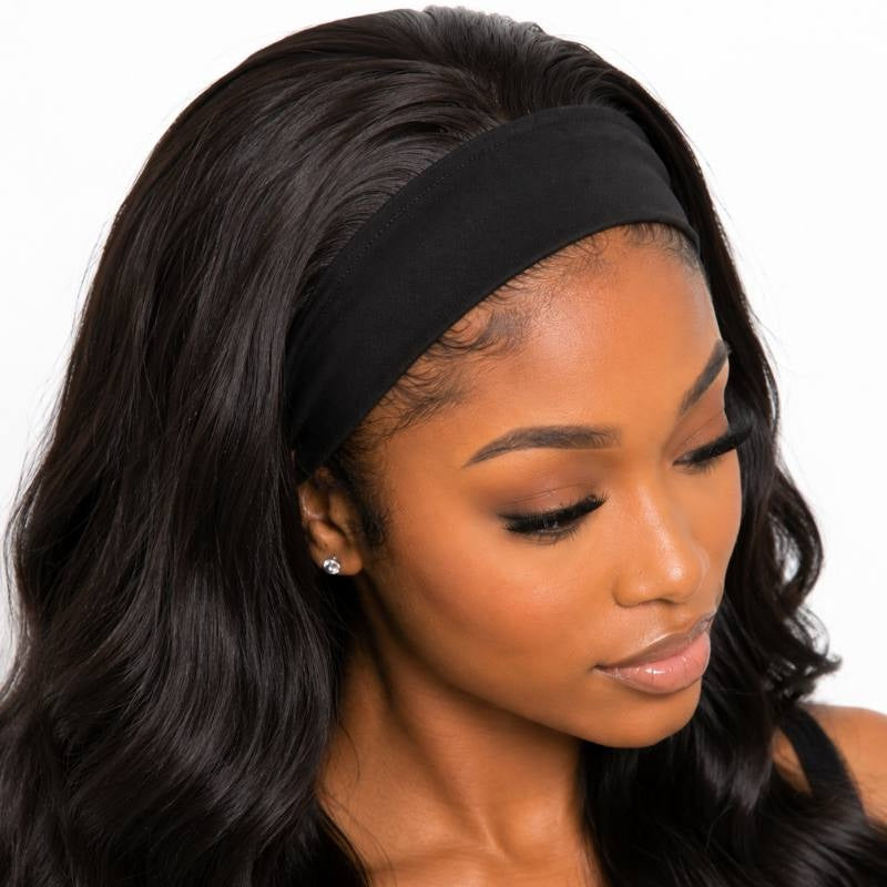 Close-up of the black stretch band on a body wave natural black headband human hair wig with the model looking down