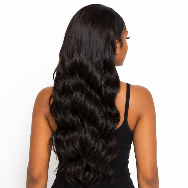 Back view of a model in a body wave natural black headband human hair wig showing waves down the back and the band at the crown
