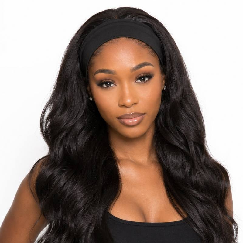 Model facing forward wearing a body wave natural black headband human hair wig with a black stretch band across the front